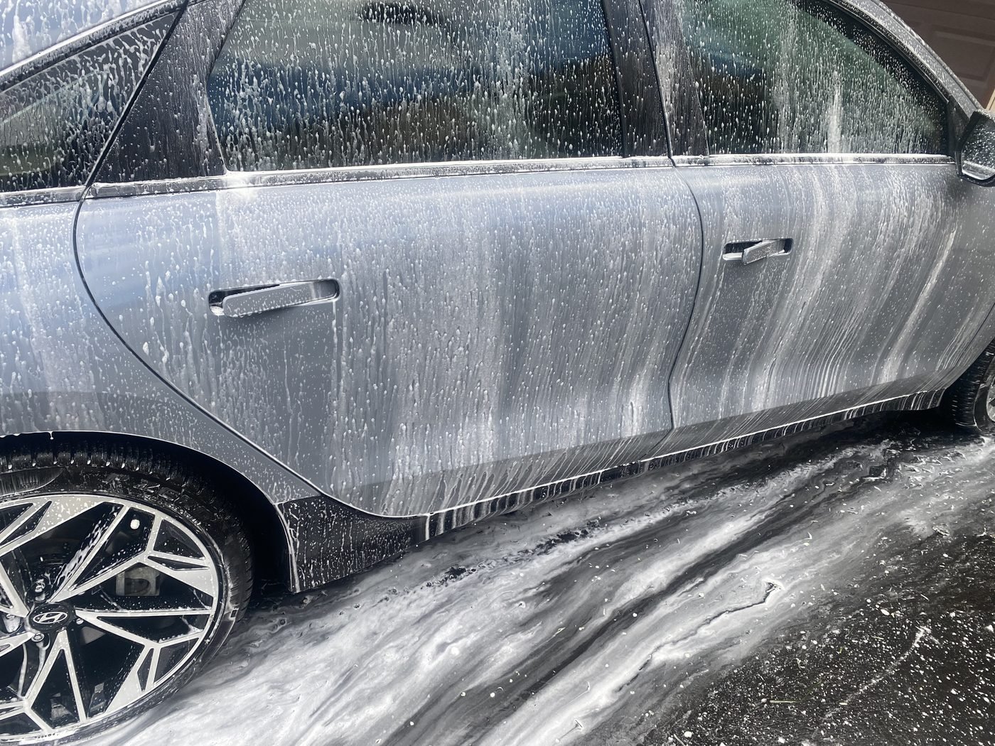 Grey Hyundai covered in foam during exterior hand wash